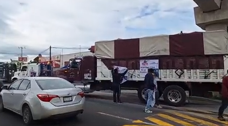 Transportistas con camiones durante bloqueo en carretera de Tlaxcala.