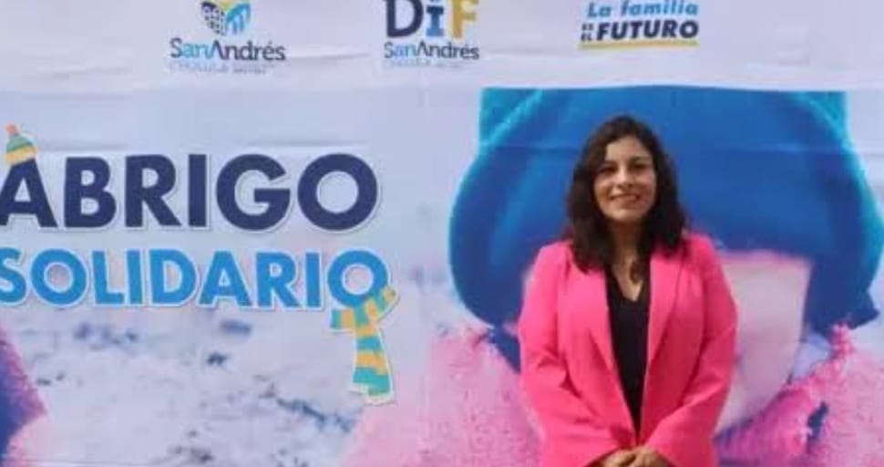 Mantiene los brazos extendidos “Abrigo Solidario” para recibir chamaras y suéteres destinados a personas vulnerables